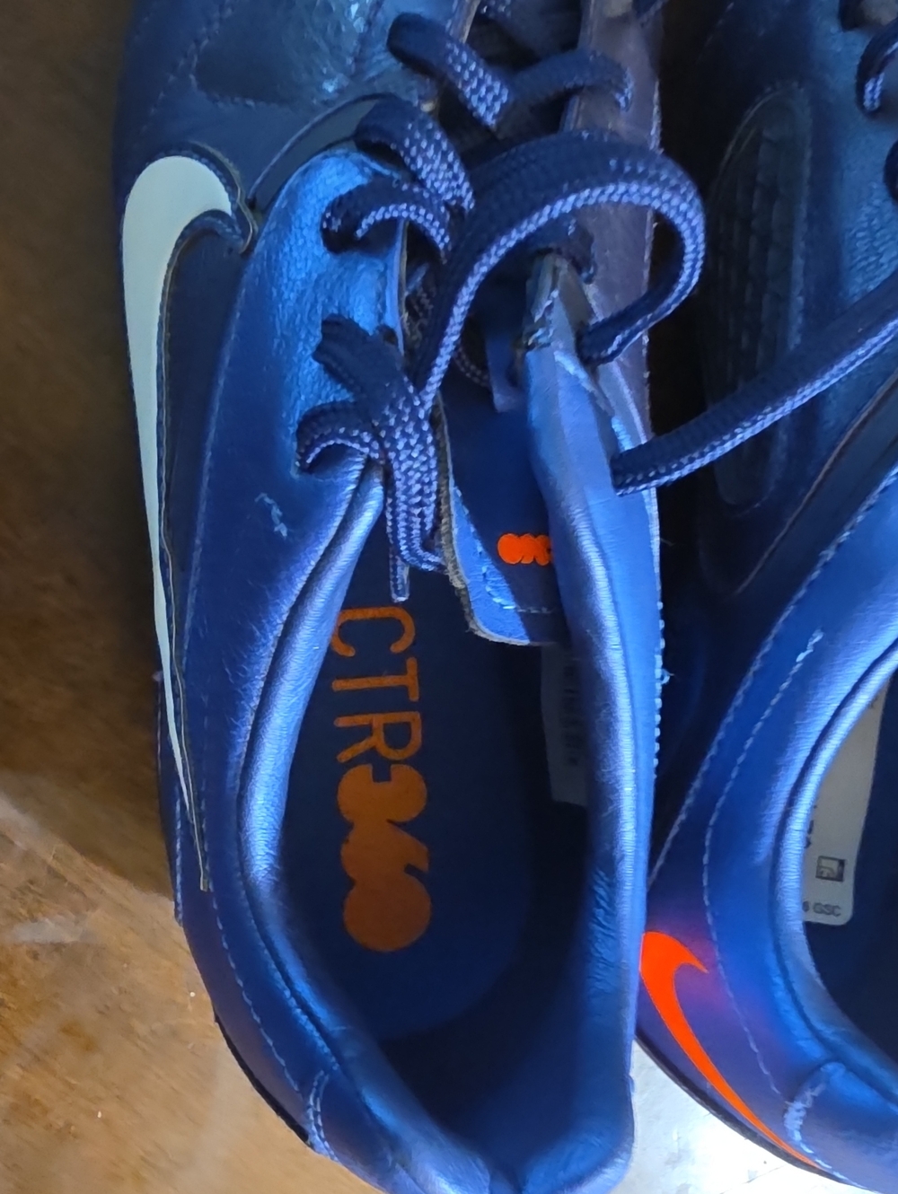 Nike Kids Navy Blue Soccer Sneakers with Orange Swoosh